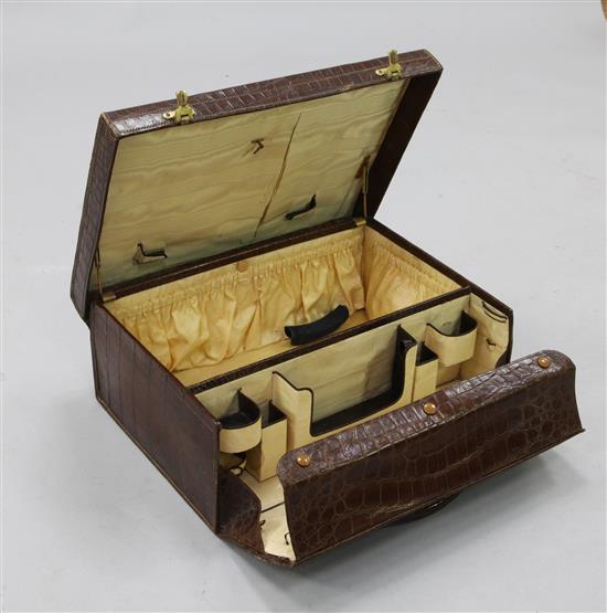 An early 20th century Drew & Sons crocodile toilet case, 20in.